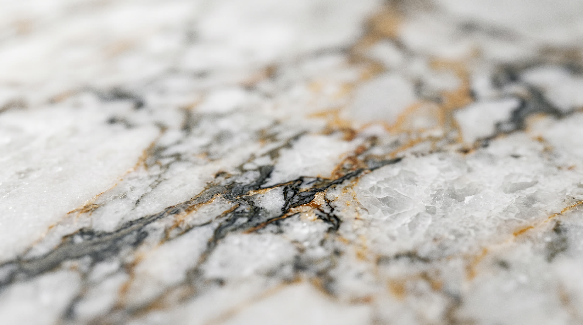 Macro of Calacatta Viola marble veining under raking light